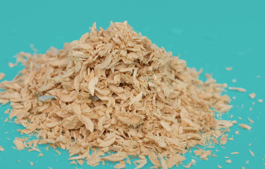 small pile of sawdust on a blue background