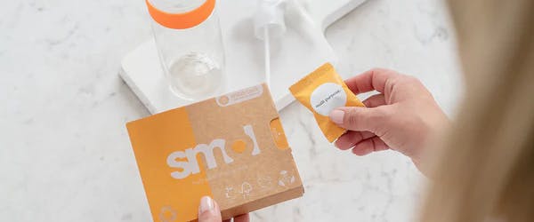 smol multi purpose tablet next to its orange packaging