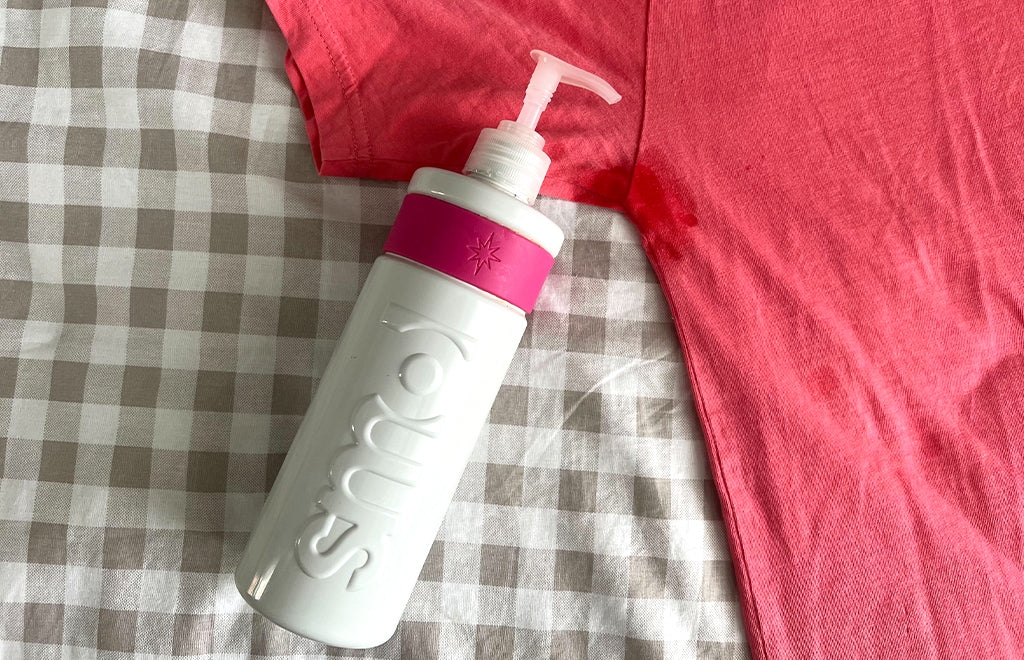 tshirt with sweat stain next to smol stain gel bottle