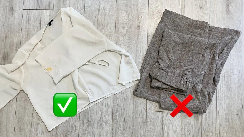a shirt with a mark on with a tick emoji on top, and some unmarked trousers with a cross emoji on top