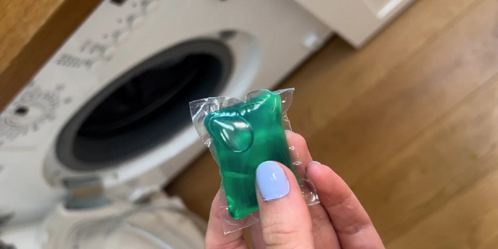 laundry capsule going into machine