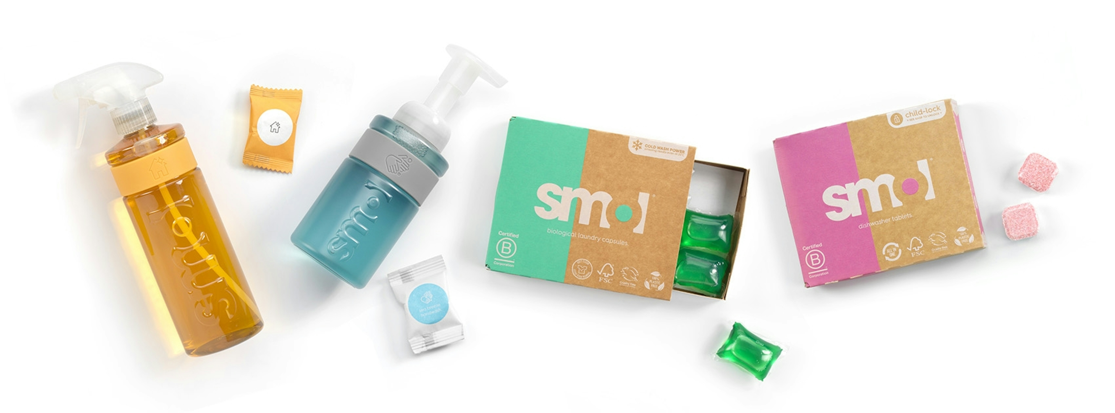 smol multi purpose, foaming handwash, laundry capsules and dishwasher tablet packs in a flat lay
