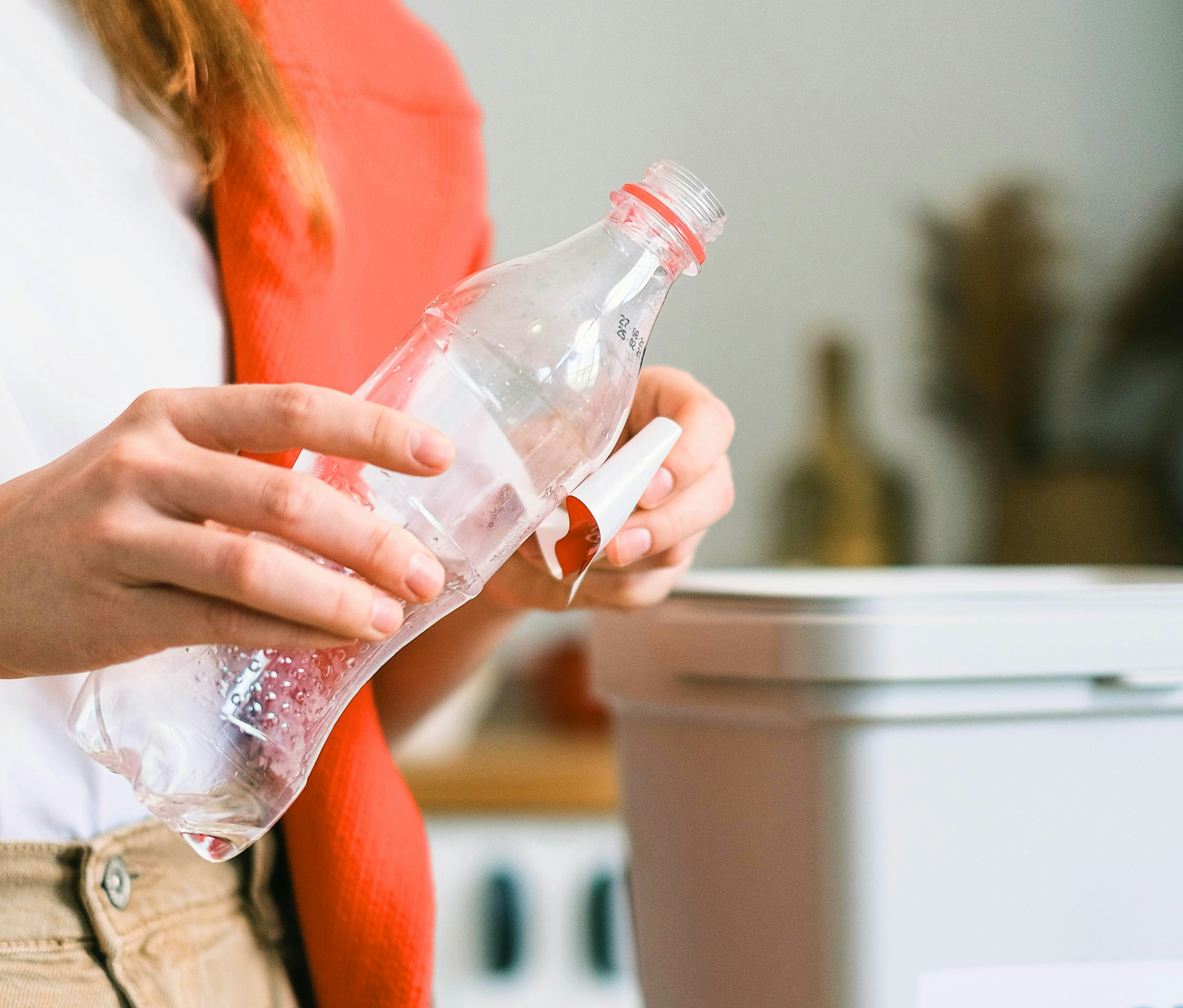 a plastic bottle near a recycling bin