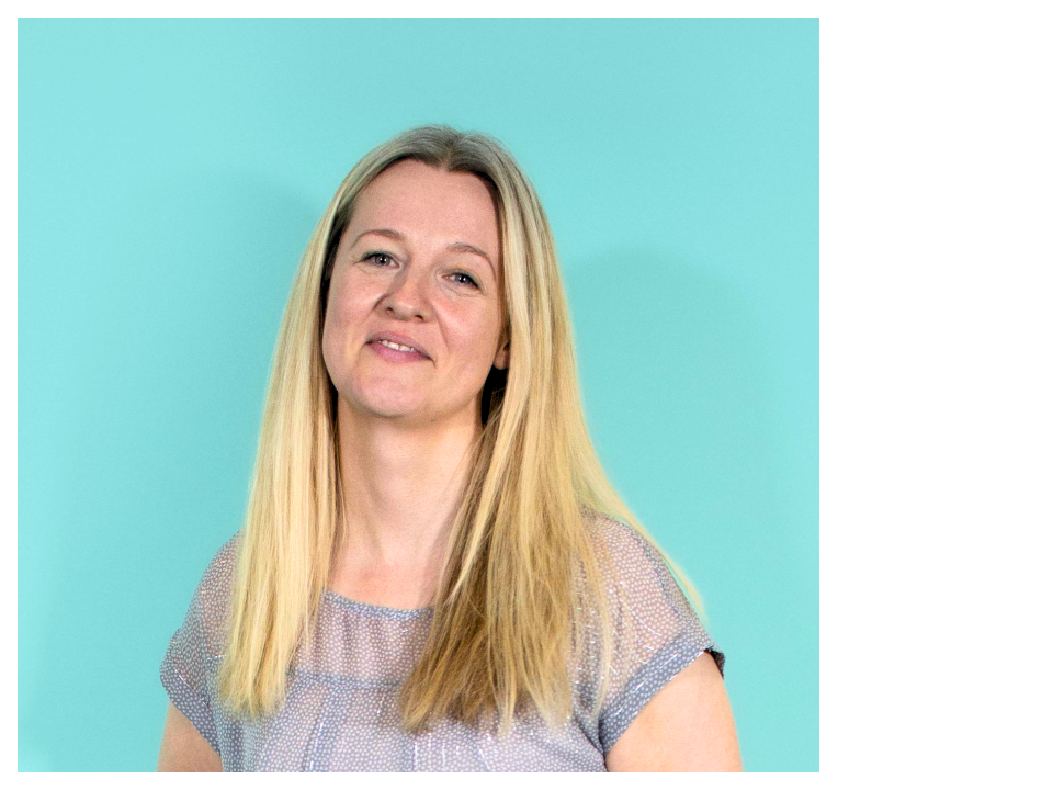 catherine green, a woman with long blonde hair is looking at the camera smiling against a blue green background