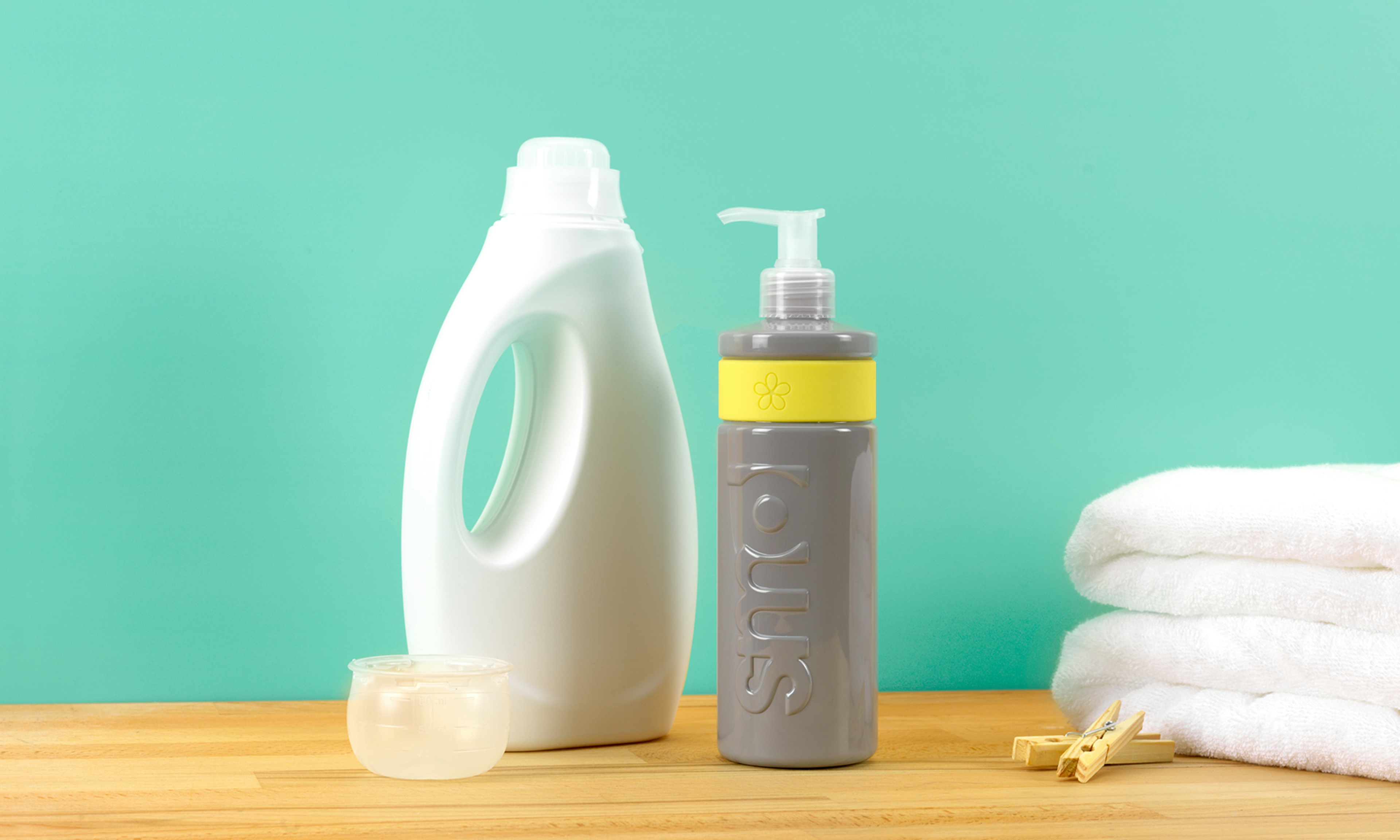 image of smol fabric conditioner next to big laundry bottle