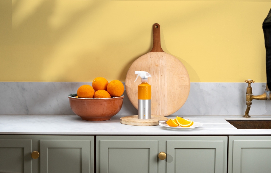 smol multipurpose spray in aluminium bottle, on a countertop next to a fruit bowl