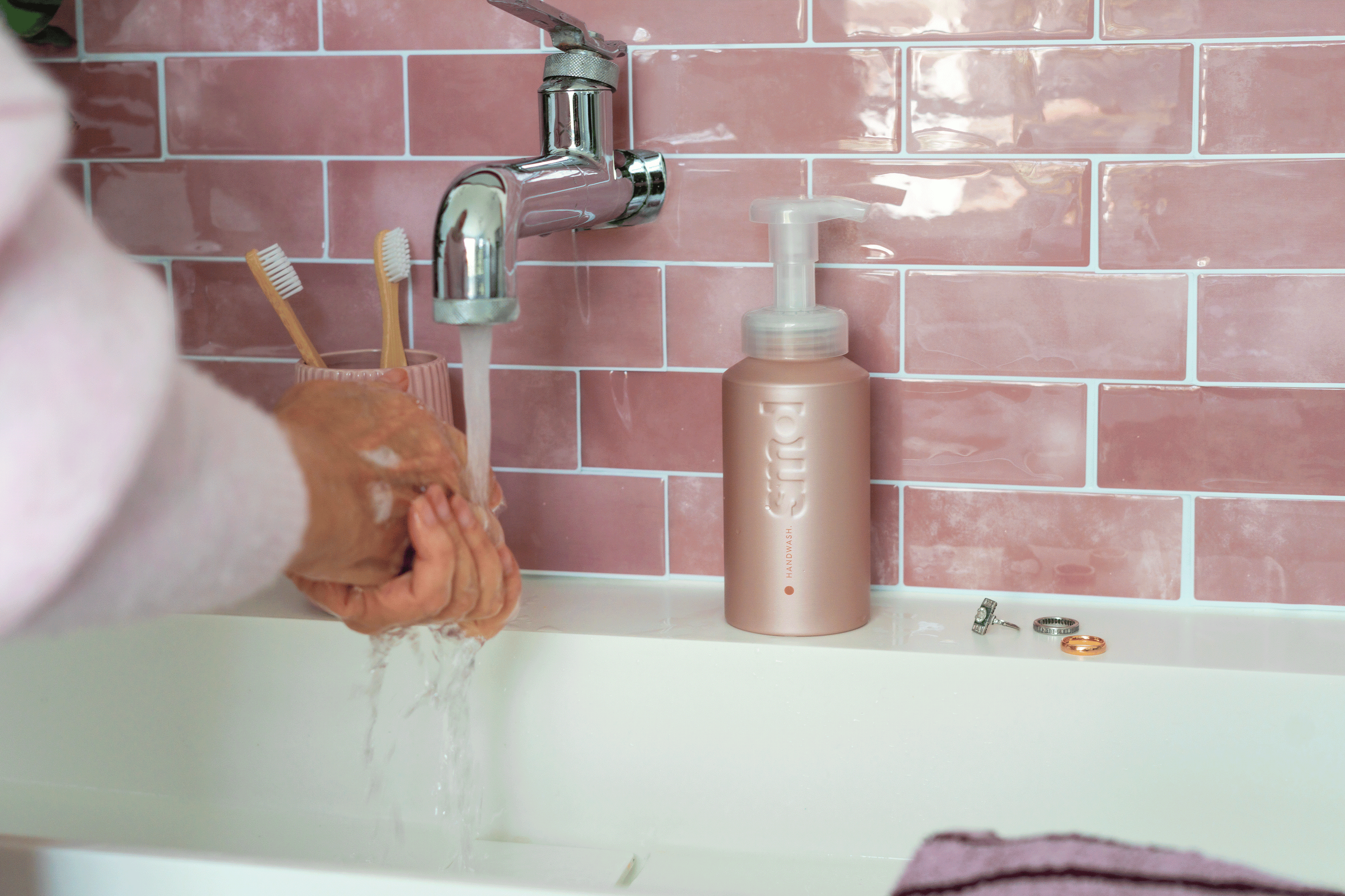 GIF of hands applying foaming handwash at sinks in multiple  bathroom 
