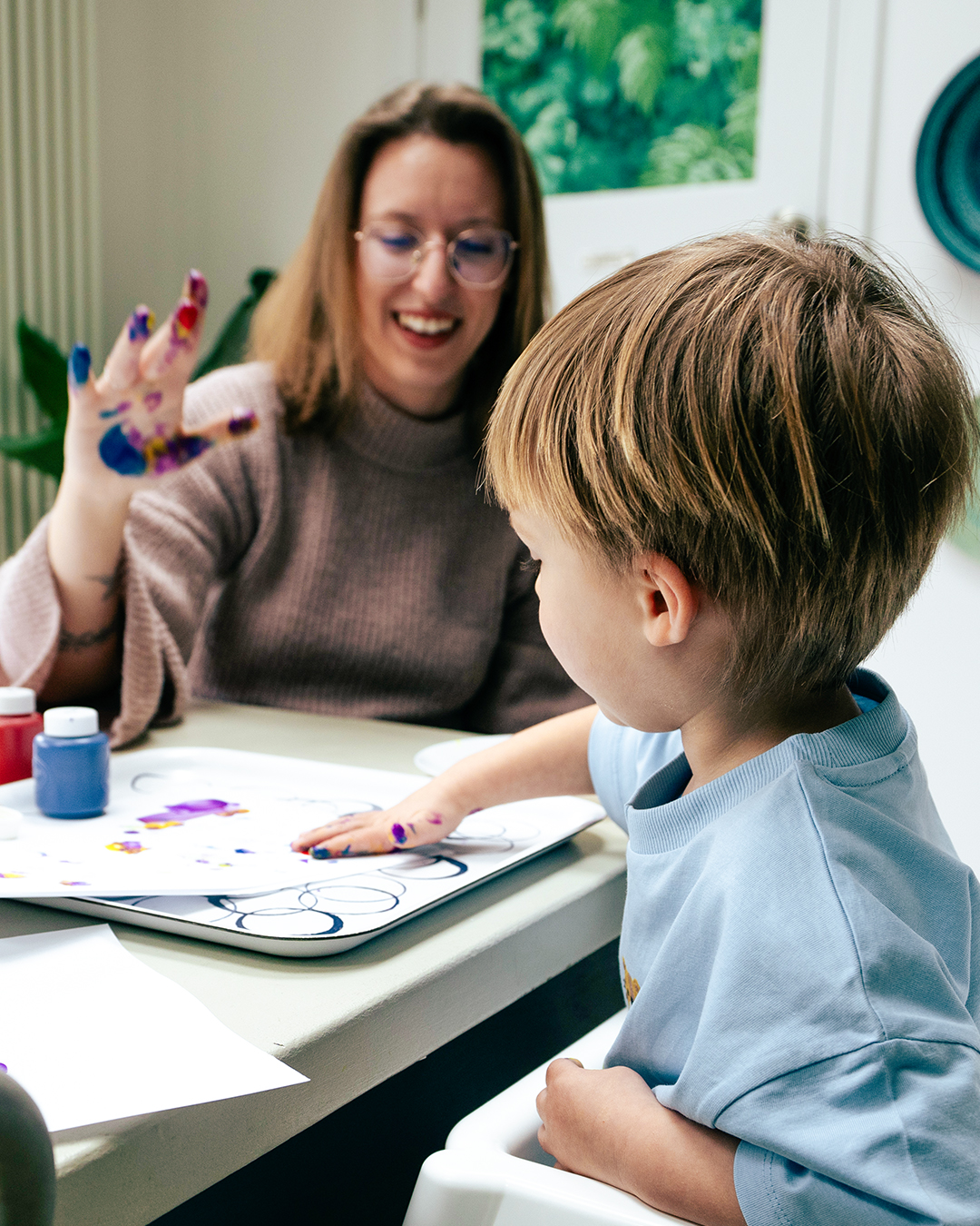 a mother and child finger painting