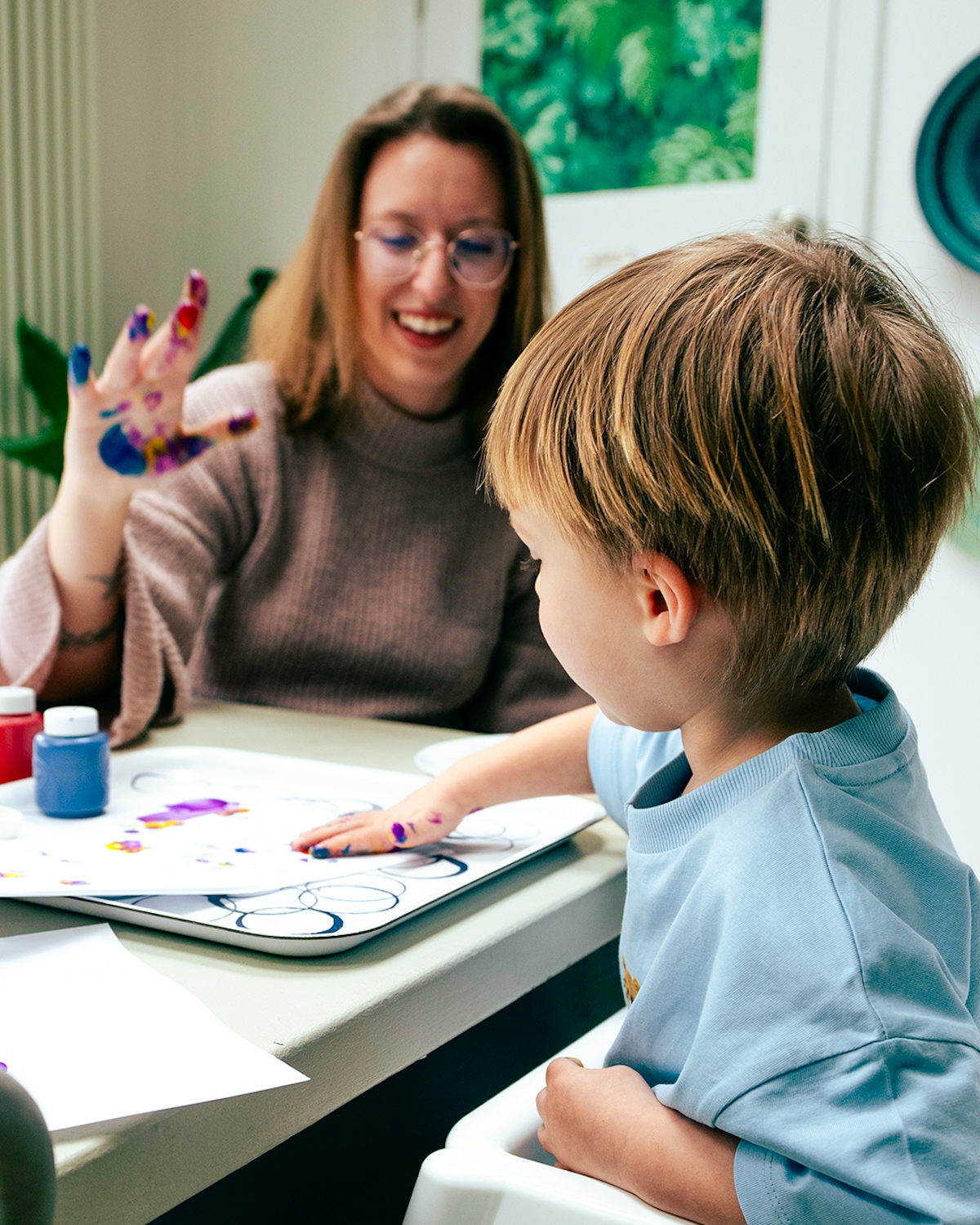 a mother and child finger painting